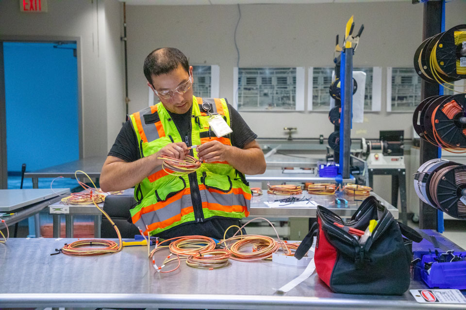 6I2A7330_Team_Member_Working_Cables_v2